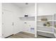 Laundry room featuring modern appliances and shelving and lots of storage for a tidy space at 17801 W Mission Ln, Waddell, AZ 85355