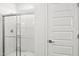 A modern bathroom shower with sleek glass doors and contemporary fixtures and a white interior at 17801 W Mission Ln, Waddell, AZ 85355