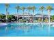 Resort-style pool area with palm trees, lounge chairs, and umbrellas, creating a relaxing oasis at 17960 W Long Lake Rd, Goodyear, AZ 85338