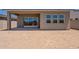 View of the backyard with a covered patio and windows, perfect for outdoor relaxation and entertaining at 17966 W Long Lake Rd, Goodyear, AZ 85338