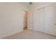 Bright bedroom featuring neutral carpet, sliding closet doors, and natural light at 17966 W Long Lake Rd, Goodyear, AZ 85338