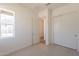 Well-lit bedroom with sliding closet doors and view to exterior at 17966 W Long Lake Rd, Goodyear, AZ 85338