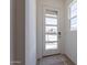 Bright entryway featuring natural light from the sidelight window and stylish modern door with glass panels at 17966 W Long Lake Rd, Goodyear, AZ 85338