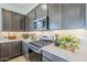 Close up of a kitchen featuring stainless steel appliances and granite countertops at 17966 W Long Lake Rd, Goodyear, AZ 85338