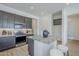 Modern kitchen features gray cabinets, stainless steel appliances, and a granite island with seating at 17966 W Long Lake Rd, Goodyear, AZ 85338