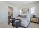 Bright main bedroom featuring a decorative painting and natural light at 17966 W Long Lake Rd, Goodyear, AZ 85338
