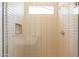 Modern tiled shower with glass door and built-in niche at 17966 W Long Lake Rd, Goodyear, AZ 85338