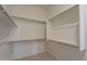 Spacious walk-in closet with ample shelving and metal rods for optimal storage at 17966 W Long Lake Rd, Goodyear, AZ 85338