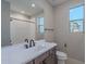 Bright bathroom with window, modern vanity, and framed mirror; features white countertops and a toilet at 2121 W Sonoran Desert Dr # 95, Phoenix, AZ 85085