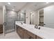 Modern bathroom features a double sink vanity, stone-look tile shower, and a large mirror at 2121 W Sonoran Desert Dr # 95, Phoenix, AZ 85085