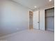 Neutral bedroom features a sliding door closet with carpeted floors and natural light at 2121 W Sonoran Desert Dr # 95, Phoenix, AZ 85085