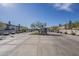 Community entrance with desert landscaping, paved roads, and contemporary home exteriors under a blue sky at 2121 W Sonoran Desert Dr # 95, Phoenix, AZ 85085