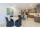 Bright dining area adjacent to a gourmet kitchen features stylish decor and modern lighting at 2121 W Sonoran Desert Dr # 95, Phoenix, AZ 85085