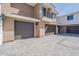 A view of the townhome garages and parking area, with brick pavers at 2121 W Sonoran Desert Dr # 95, Phoenix, AZ 85085