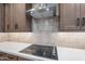 Contemporary kitchen showcasing stainless steel range hood, glass cooktop, and neutral backsplash at 2121 W Sonoran Desert Dr # 95, Phoenix, AZ 85085