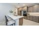 Beautiful kitchen with stainless steel appliances, island with seating, and stylish cabinets at 2121 W Sonoran Desert Dr # 95, Phoenix, AZ 85085