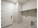 Functional laundry room with ample shelving and utility connections for appliances at 2121 W Sonoran Desert Dr # 95, Phoenix, AZ 85085