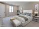 Serene main bedroom showcases a plush bed, elegant decor, and a window providing natural light at 2121 W Sonoran Desert Dr # 95, Phoenix, AZ 85085