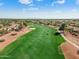 Expansive aerial view of the lush green golf course, showcasing the community's layout and distant mountain views at 23024 N De La Guerra Ct, Sun City West, AZ 85375