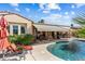 Beautiful backyard with a pool, covered patio, and seating area, perfect for outdoor living at 23024 N De La Guerra Ct, Sun City West, AZ 85375