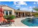 Beautiful backyard with a pool, covered patio, and seating area, perfect for outdoor living at 23024 N De La Guerra Ct, Sun City West, AZ 85375