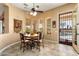 Breakfast nook with a view of the pool and a decorative ceiling fan at 23024 N De La Guerra Ct, Sun City West, AZ 85375