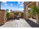 Serene courtyard with stone flooring, a cozy seating area, and lush greenery providing a private retreat at 23024 N De La Guerra Ct, Sun City West, AZ 85375