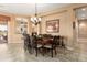 Well-lit dining area featuring a stylish chandelier and convenient access to the kitchen at 23024 N De La Guerra Ct, Sun City West, AZ 85375