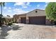 Inviting single-story home with a spacious three-car garage and a well-maintained front yard and stone accents at 23024 N De La Guerra Ct, Sun City West, AZ 85375