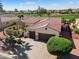 Gorgeous aerial view of a home with a pristine golf course, beautiful landscaping, and a paver driveway at 23024 N De La Guerra Ct, Sun City West, AZ 85375