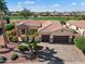 Stunning aerial shot of home with lush landscaping, paver driveway, and easy access to a golf course at 23024 N De La Guerra Ct, Sun City West, AZ 85375