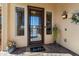 Charming front entrance with a decorative door, sidelight windows, and a welcoming 'hello' doormat at 23024 N De La Guerra Ct, Sun City West, AZ 85375