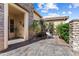 Welcoming front entrance featuring a stone pathway, charming decor, and an inviting covered entryway at 23024 N De La Guerra Ct, Sun City West, AZ 85375