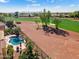 Breathtaking aerial view of a backyard with pool access to a pristine golf course, lush landscaping, and serene views at 23024 N De La Guerra Ct, Sun City West, AZ 85375