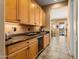 Hallway featuring custom cabinets, granite countertops, and a built-in wine refrigerator at 23024 N De La Guerra Ct, Sun City West, AZ 85375