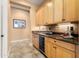 Hallway featuring custom cabinets, granite countertops, and a built-in wine refrigerator at 23024 N De La Guerra Ct, Sun City West, AZ 85375