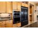 Modern kitchen highlighting stainless steel appliances, granite counters, and wood cabinets at 23024 N De La Guerra Ct, Sun City West, AZ 85375