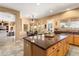 Kitchen with a granite-topped island providing seating and overlooking a breakfast nook at 23024 N De La Guerra Ct, Sun City West, AZ 85375