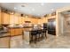 Open kitchen featuring granite countertops, an island with seating, and stainless steel appliances at 23024 N De La Guerra Ct, Sun City West, AZ 85375