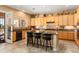 Bright kitchen featuring granite countertops, a central island, and modern appliances at 23024 N De La Guerra Ct, Sun City West, AZ 85375