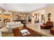 Spacious living area with tile floors that connect the kitchen, living, and dining spaces at 23024 N De La Guerra Ct, Sun City West, AZ 85375