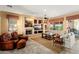 Inviting living room featuring a fireplace, entertainment center and ample seating at 23024 N De La Guerra Ct, Sun City West, AZ 85375