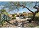 Beautiful backyard featuring a pool, patio, desert landscaping and mature tree at 2534 W Muirfield Dr, Anthem, AZ 85086