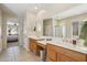 Bright bathroom features dual sinks, tile floors, and a large mirror at 2534 W Muirfield Dr, Anthem, AZ 85086