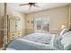 Comfortable bedroom featuring a ceiling fan, window with shutters, and decor at 2534 W Muirfield Dr, Anthem, AZ 85086