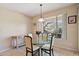 Cozy dining area with round glass table, pendant lighting and beautiful desert view at 2534 W Muirfield Dr, Anthem, AZ 85086