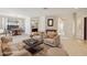 Staged living room showcasing neutral colors, elegant furniture, and a view to the dining area at 2534 W Muirfield Dr, Anthem, AZ 85086