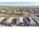 Overhead shot capturing beautiful neighborhood, green fields, mountain range in the background and desert landscaping at 25634 W Samantha Way, Buckeye, AZ 85326