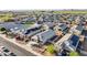 Aerial view of neighborhood featuring uniform desert landscaping, solar panels and tile roofs at 25634 W Samantha Way, Buckeye, AZ 85326