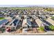 Aerial view of neighborhood showcasing similar homes, desert landscaping, tile roofs and mountain views at 25634 W Samantha Way, Buckeye, AZ 85326